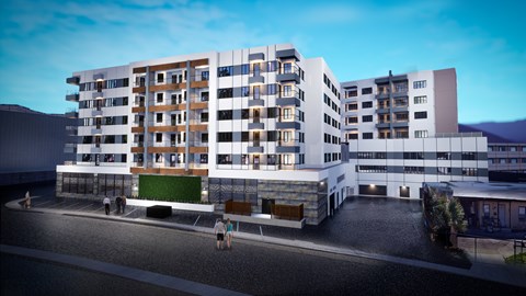 A modern apartment building with a green space in the middle.
