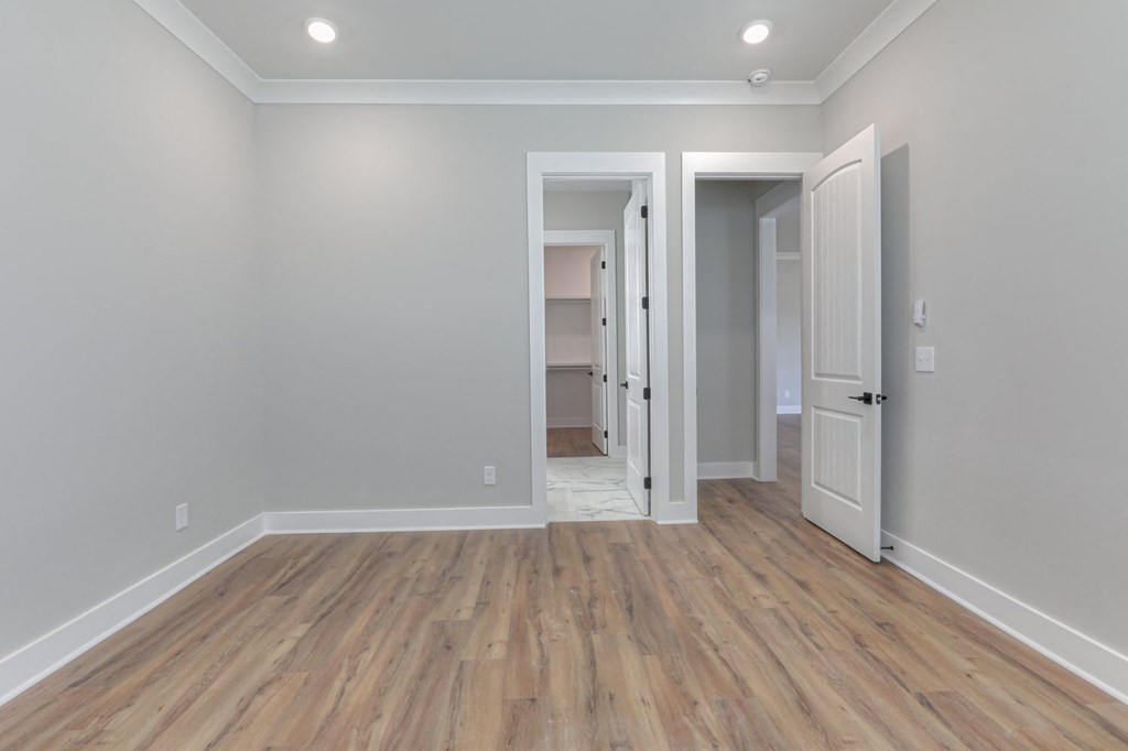 a renovated living room with wood floors and grey walls