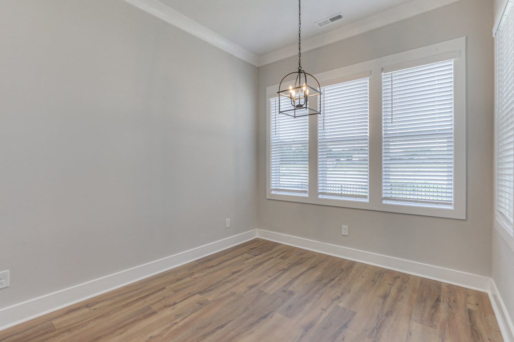 a living room with a large window and a wooden floor
