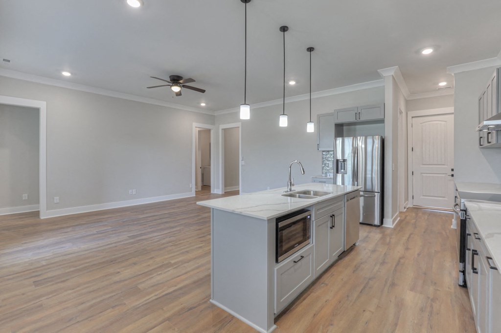 a white kitchen with a large island in the middle