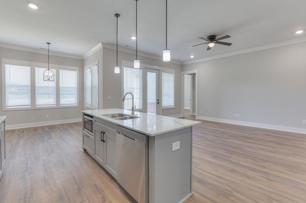 an open kitchen and living room with a large island