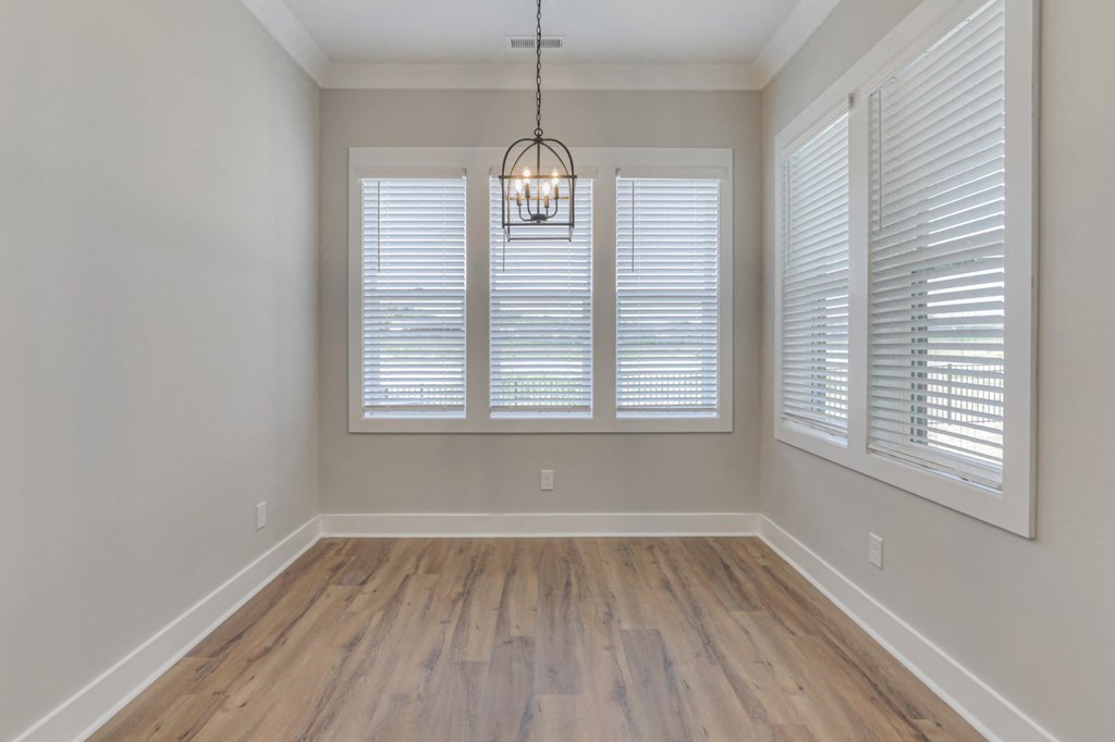 a view of a room with windows and a wood floor
