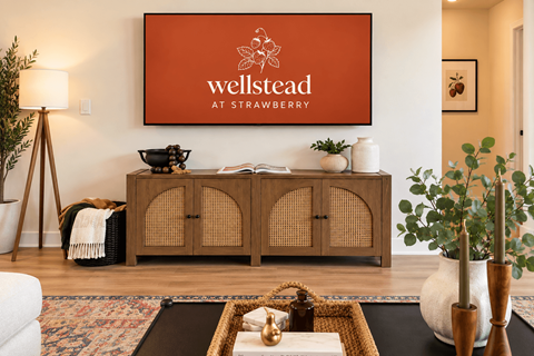 A living room with a large poster that says "wellstead at strawberry".