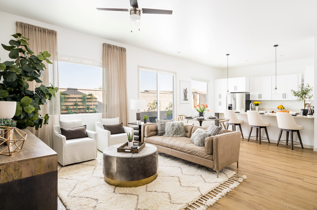a living room with white walls and hardwood floors