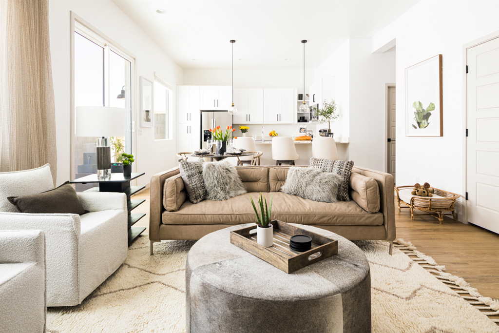 a living room with white walls and a brown couch