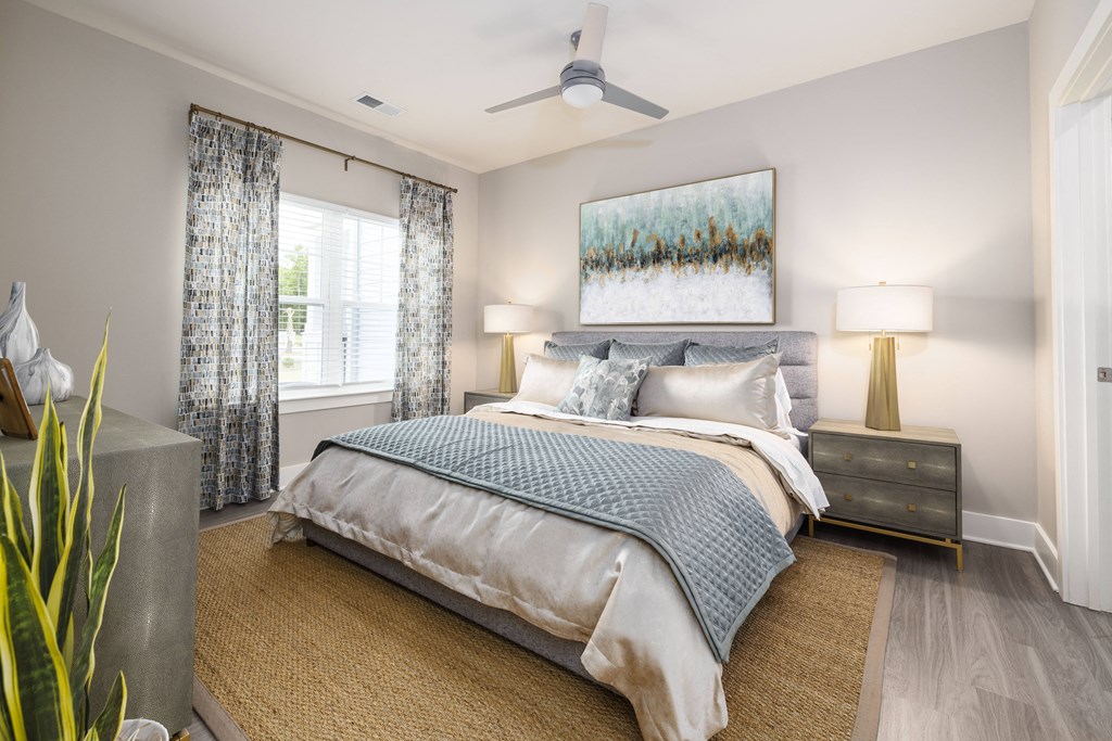 a bedroom with a bed and a ceiling fan