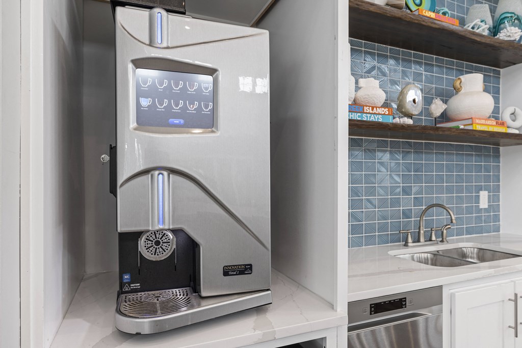 a small kitchen with a coffee machine and a sink