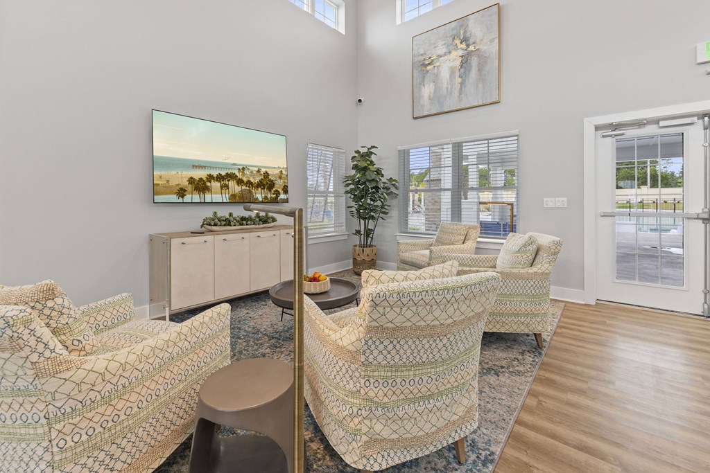 the living room of a house with chairs and a table