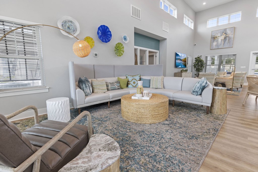 a living room with couches and chairs and a rug