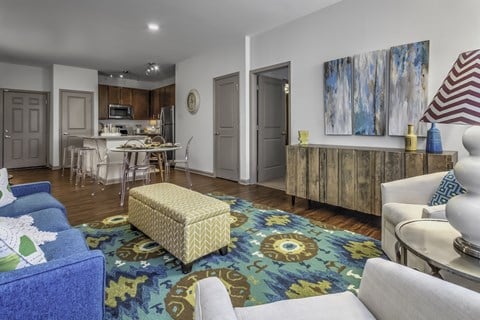 a living room with couches and a rug