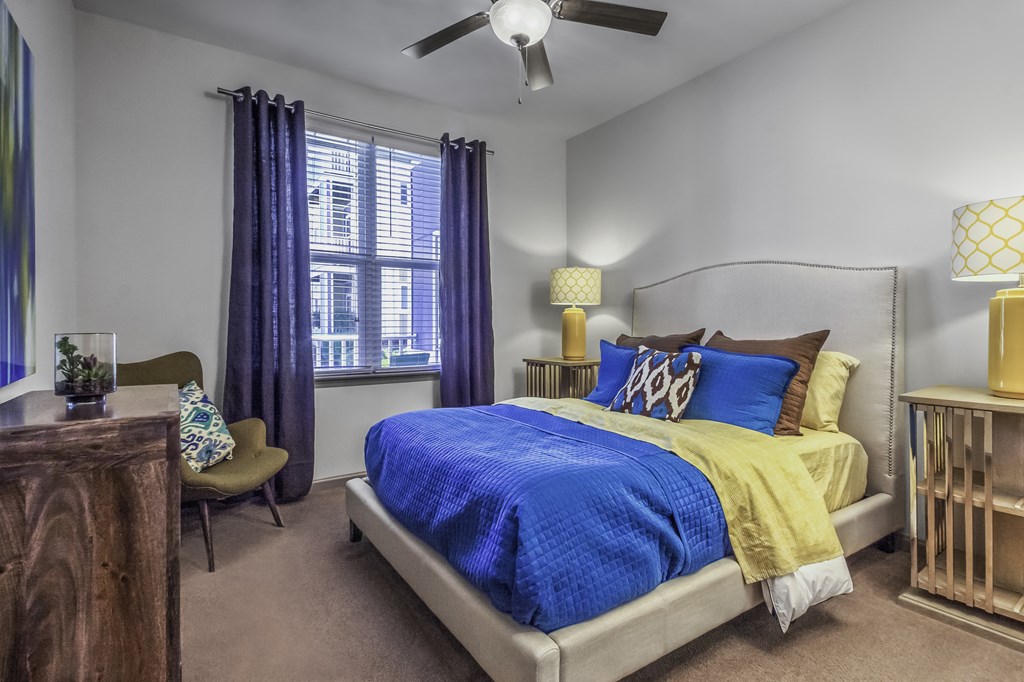 a bedroom with a bed and a ceiling fan