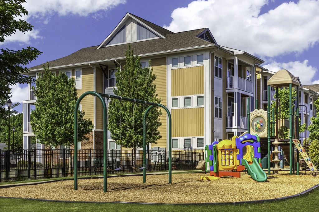 a playground in front of an apartment building