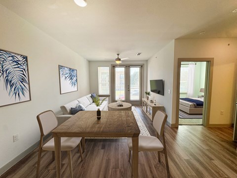 A dining room with a wooden table and chairs.