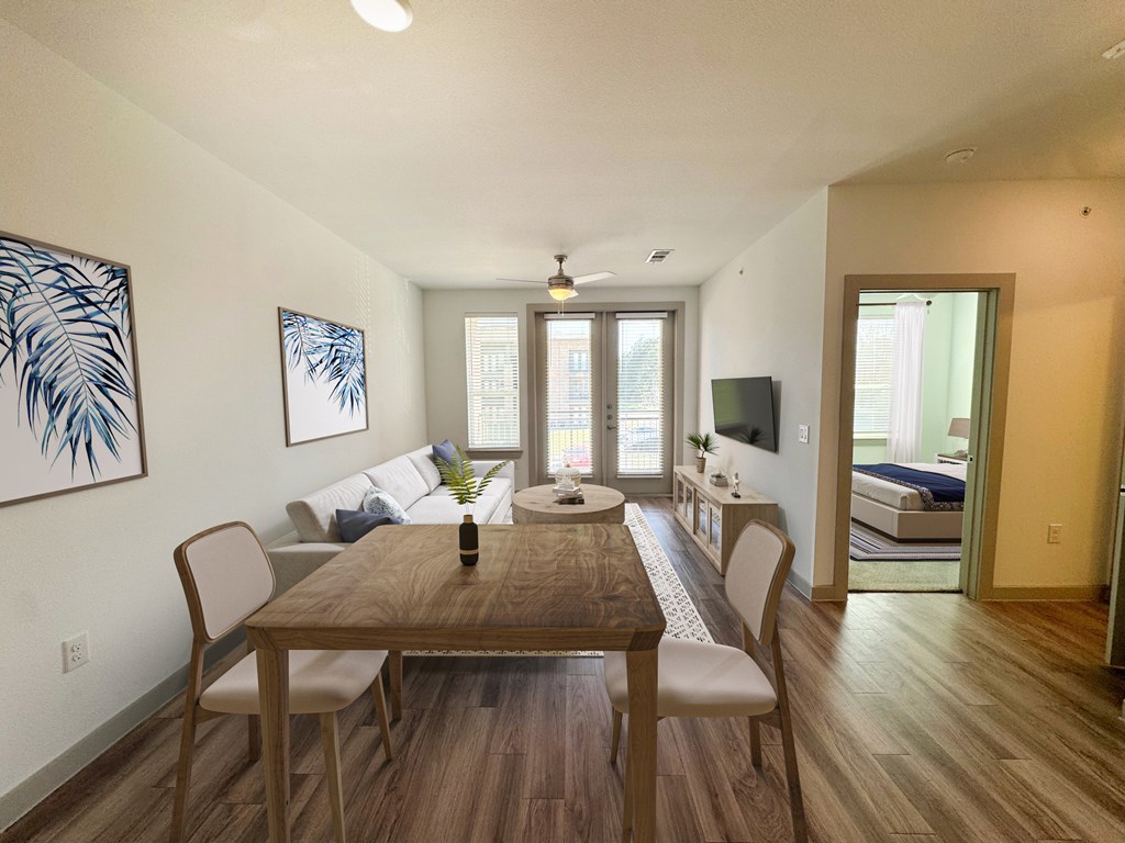 A dining room with a wooden table and chairs.