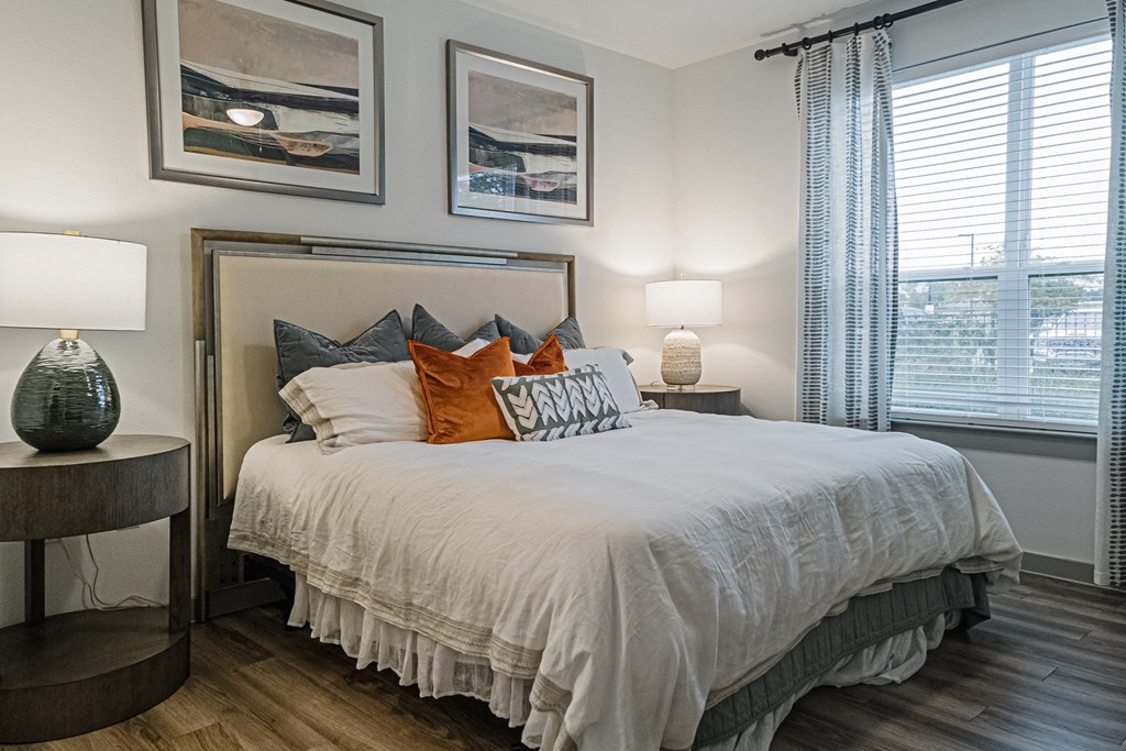 a bedroom with a bed and two windows