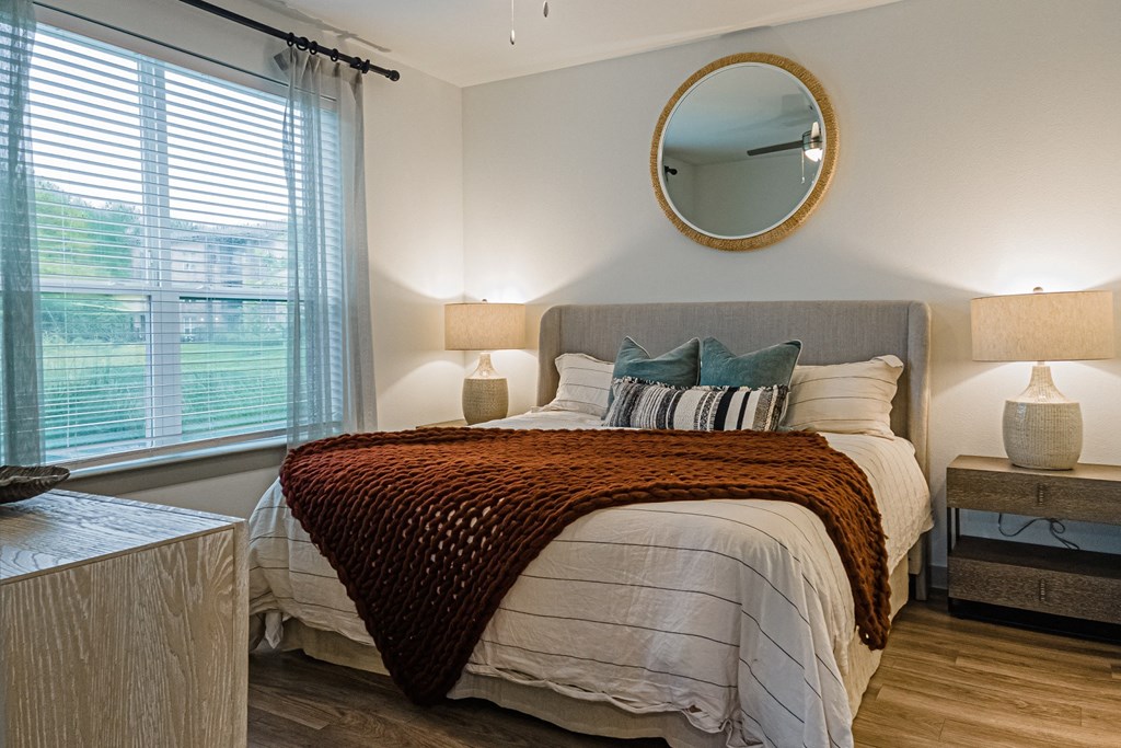 a bedroom with a bed and a window