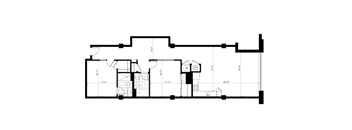 A black and white floor plan of a building with rooms and measurements.