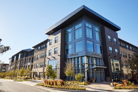 A modern building with a glass facade and a sign that reads "FRIENDLY".