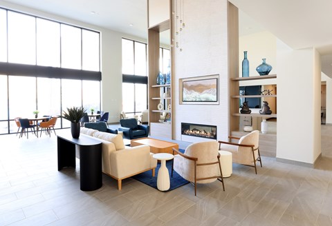 A living room with a fireplace and a painting on the wall.
