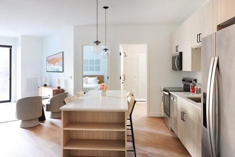 A modern kitchen with a dining table and chairs.