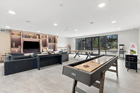 A room with a pool table and a couch.