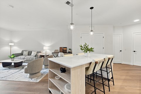 A modern dining room with a white table and chairs.
