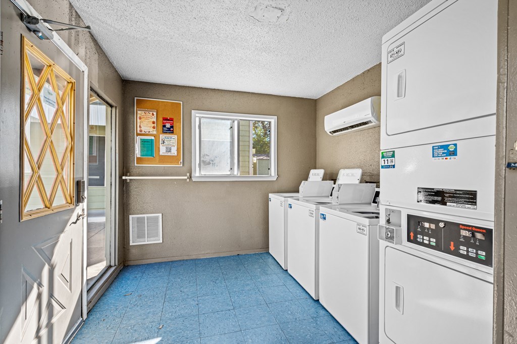 a kitchen with appliances and a window and a laundry room