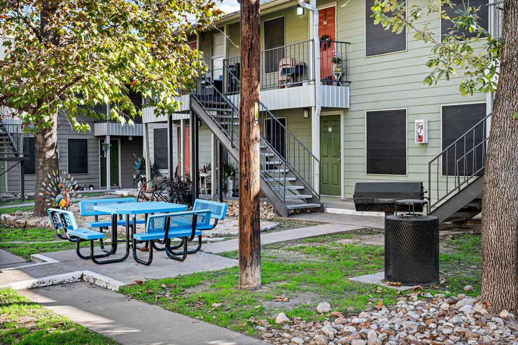 our apartments have a patio with tables and chairs