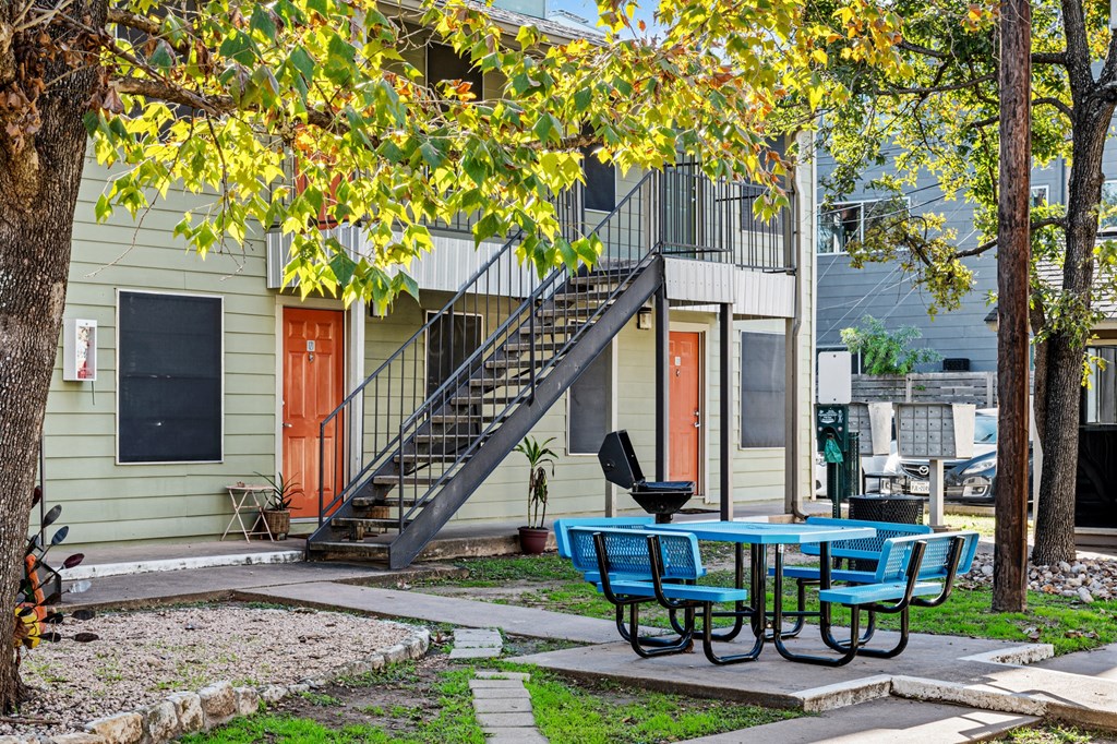 our apartments have a patio with a table and chairs