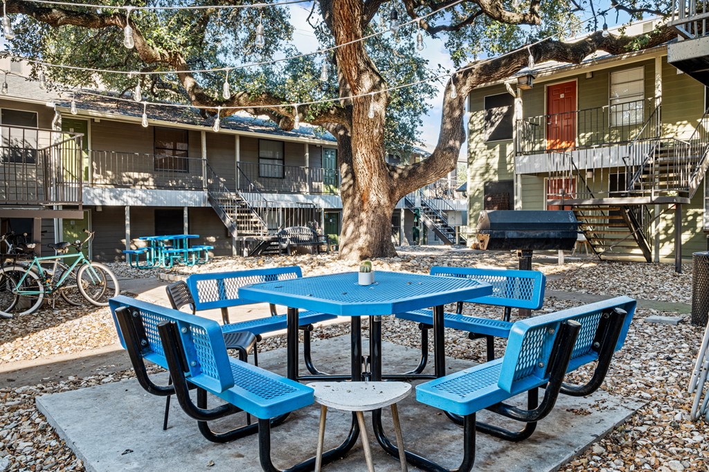 our yard is full of tables and chairs and a grill