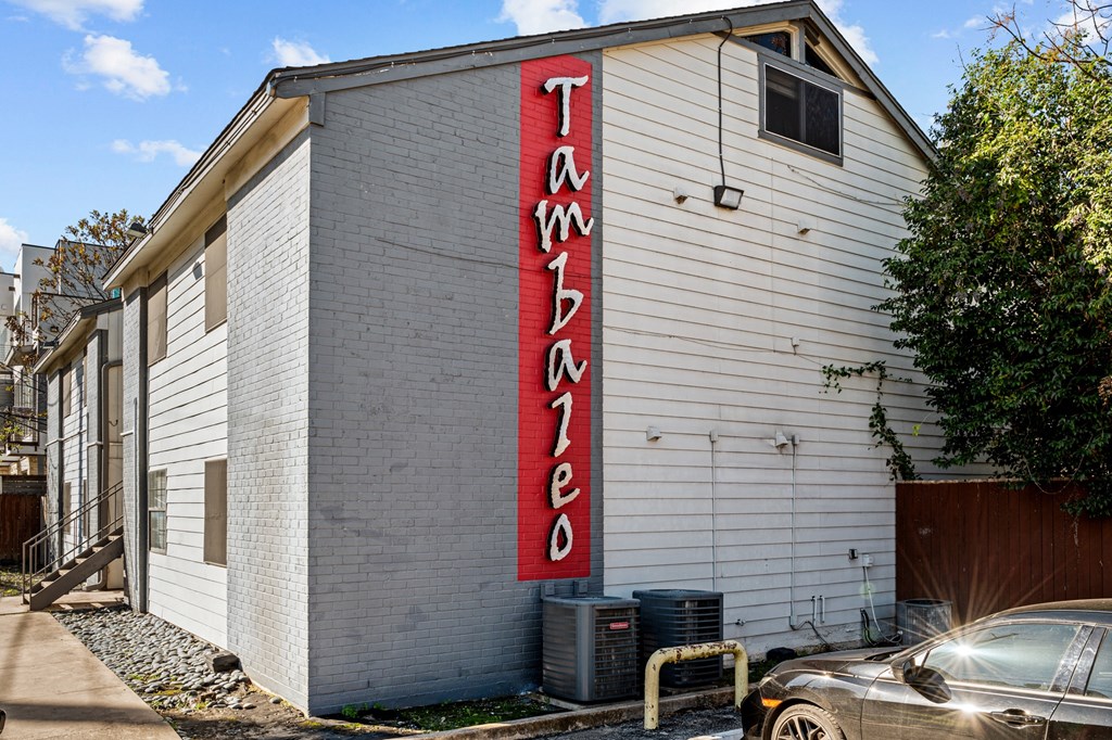 a white building with a red sign on the side of it