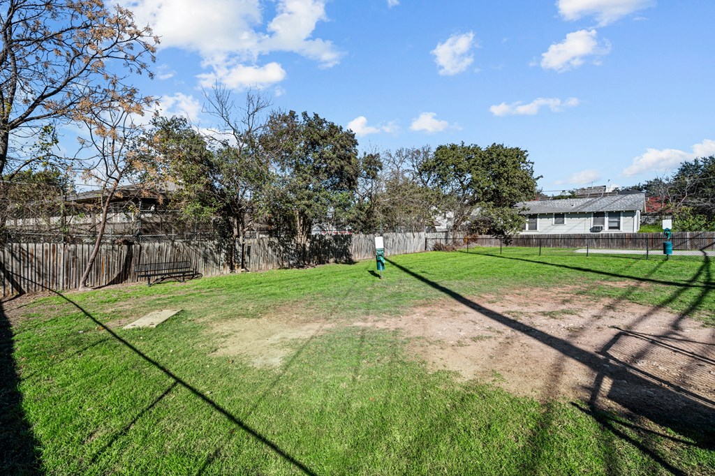 the backyard of a house with a yard and a fence