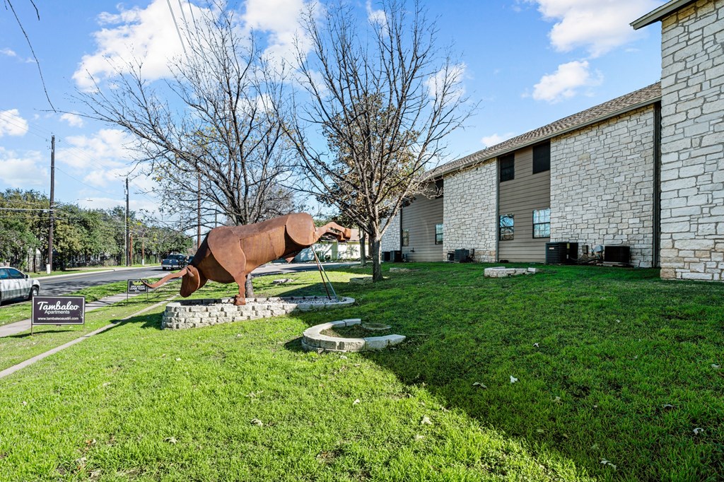 a sculpture of a horse in front of a building