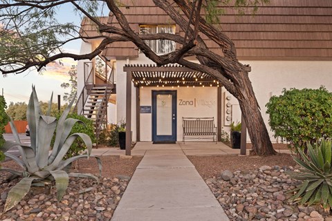 A building with a blue door and a sign that says "Zona Vllage".