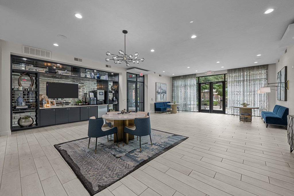 a large living room with a table and chairs and a kitchen