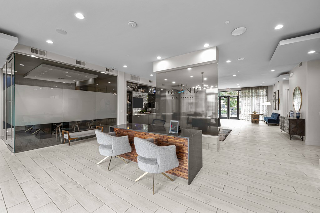 a large lobby with a reception desk and chairs