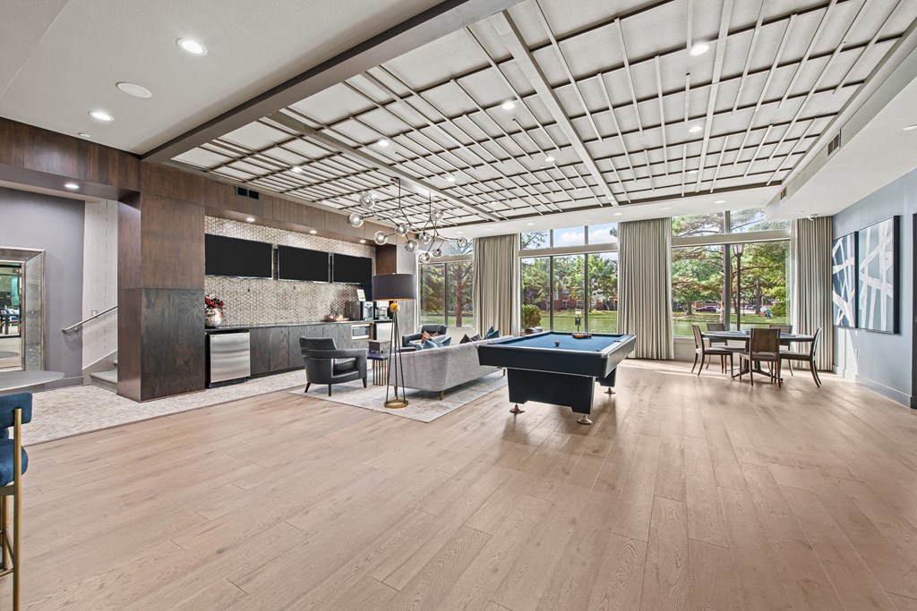 a game room with a pool table in the middle of it