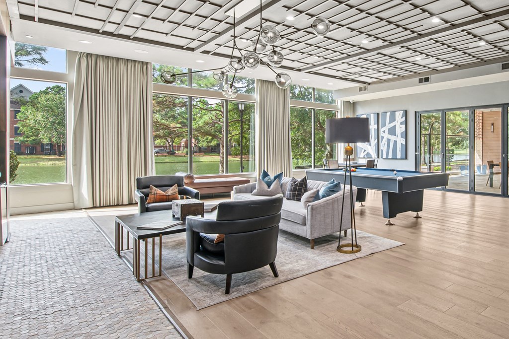 a living room with couches and a pool table