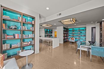 A room with a bookshelf and a table.