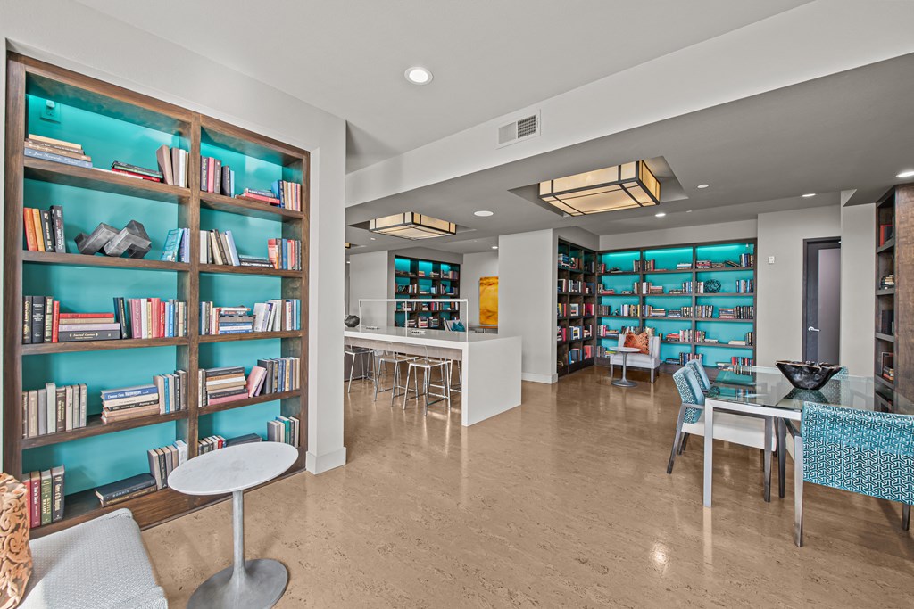 a library with tables and chairs and shelves of books