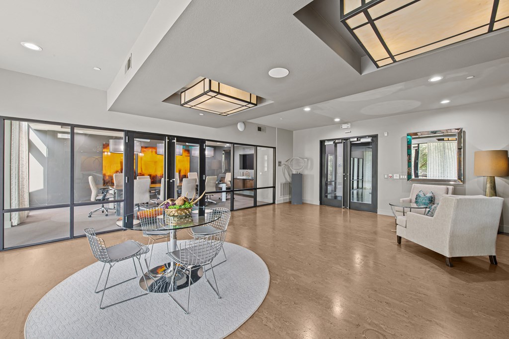a living room with glass doors and a table and chairs