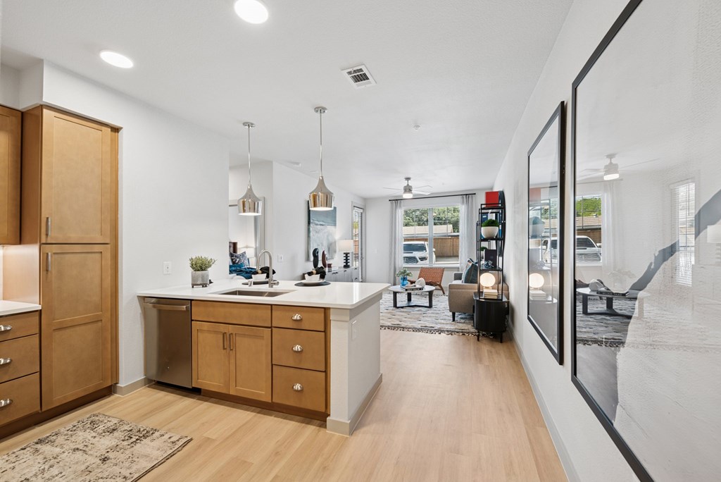 A modern kitchen with wooden cabinets and a large island.