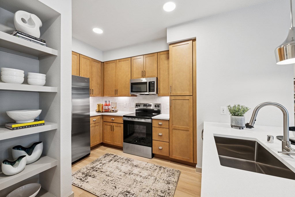 A modern kitchen with wooden cabinets and stainless steel appliances.
