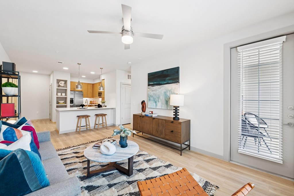A living room with a grey couch and a coffee table.