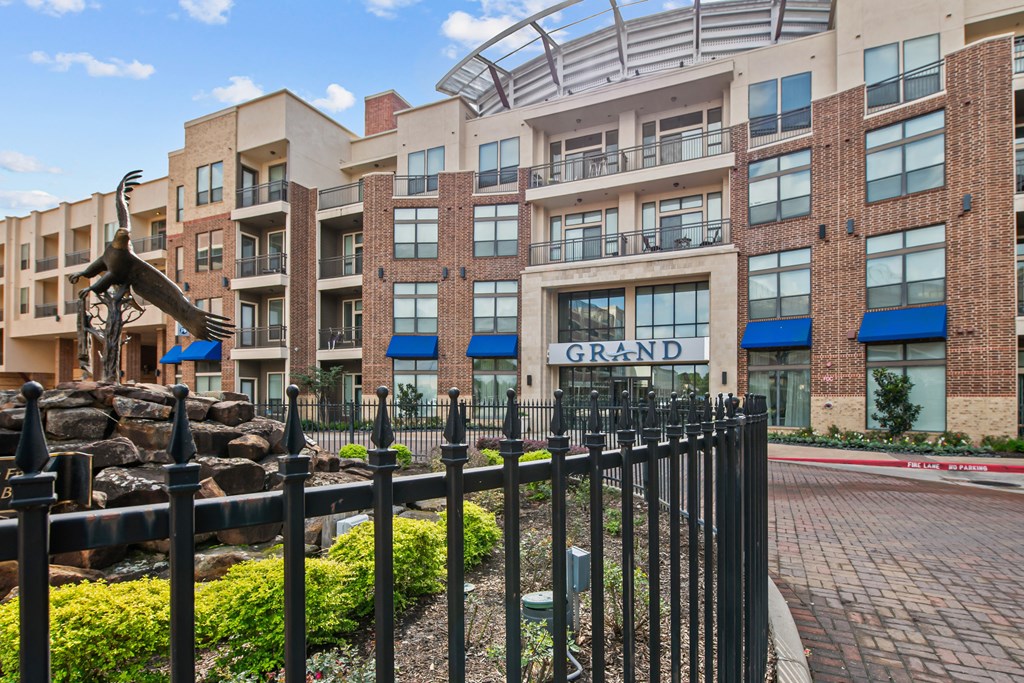 a large building with a statue and a fence in front of it