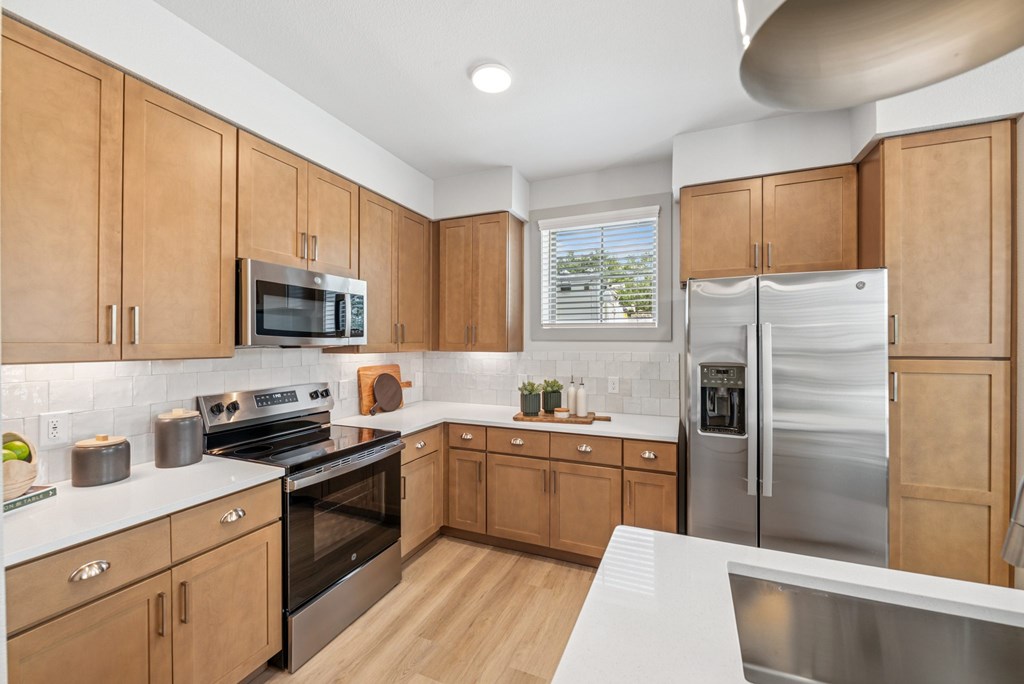 A kitchen with wooden cabinets and stainless steel appliances.