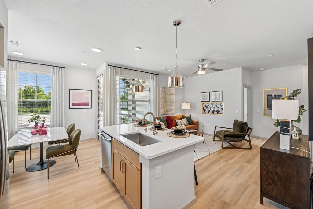 A modern kitchen with a dining table and chairs.