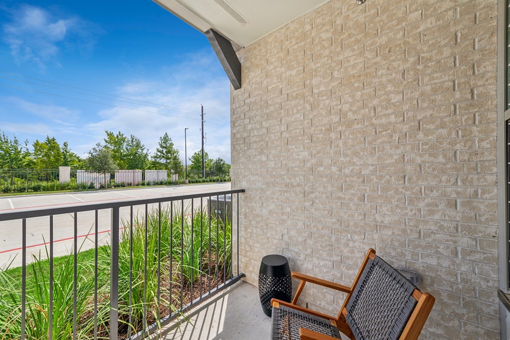 A balcony with a chair and a speaker on it.