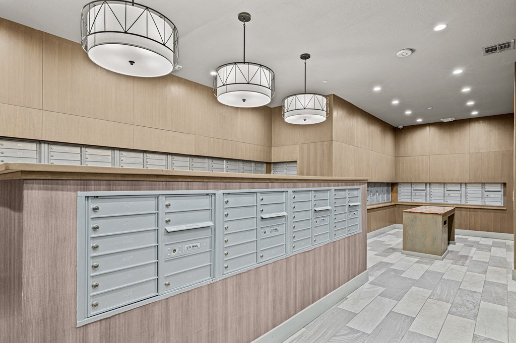 A row of mailboxes on a wall in a room.