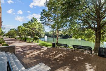 A park with benches and a fountain.